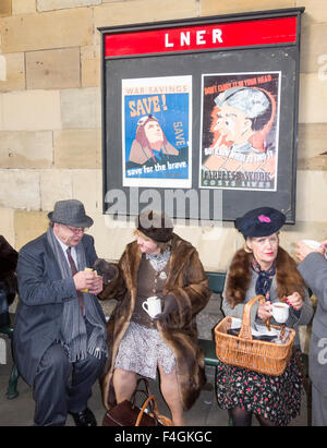 Pickering, North Yorkshire, UK. 17th October, 2015. Pickering`s annual Wartime and 40`s Weekend attracts thousands, with World War 2 living history camps and battle re-enactments amomg the attractions. PICTURED: Dressed appropriately on Pickering station platform. Stock Photo